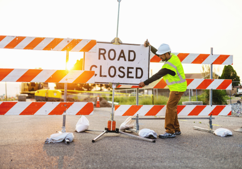 Western USA Highway, Road and Street Construction Hispanic Workers Setting Barriers and Directing Traffic